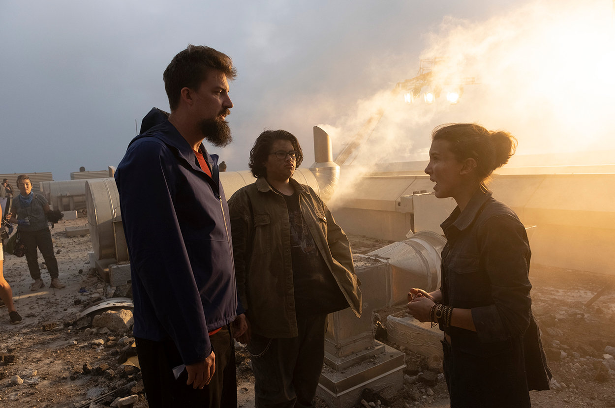 (L-r) Director ADAM WINGARD, JULIAN DENNISON and MILLIE BOBBY BROWN on the set of Warner Bros. Pictures’ and Legendary Pictures’ action adventure “GODZILLA VS. KONG,” a Warner Bros. Pictures and Legendary Pictures release.