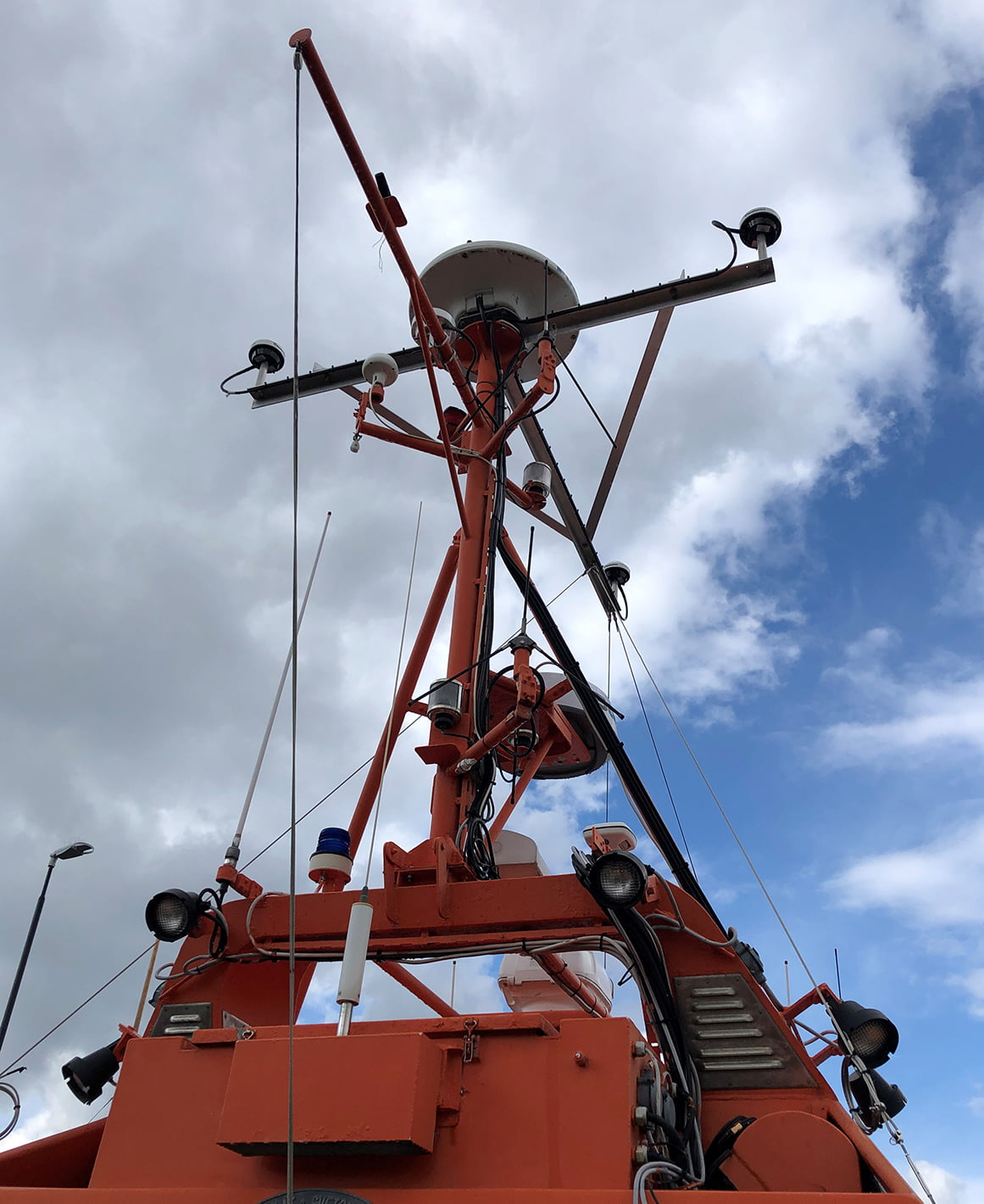 The three GNSS antennas that measure the boat's position and direction with very high accuracy.  Also visible is the radar, which provides a complete radar view around the entire boat.
