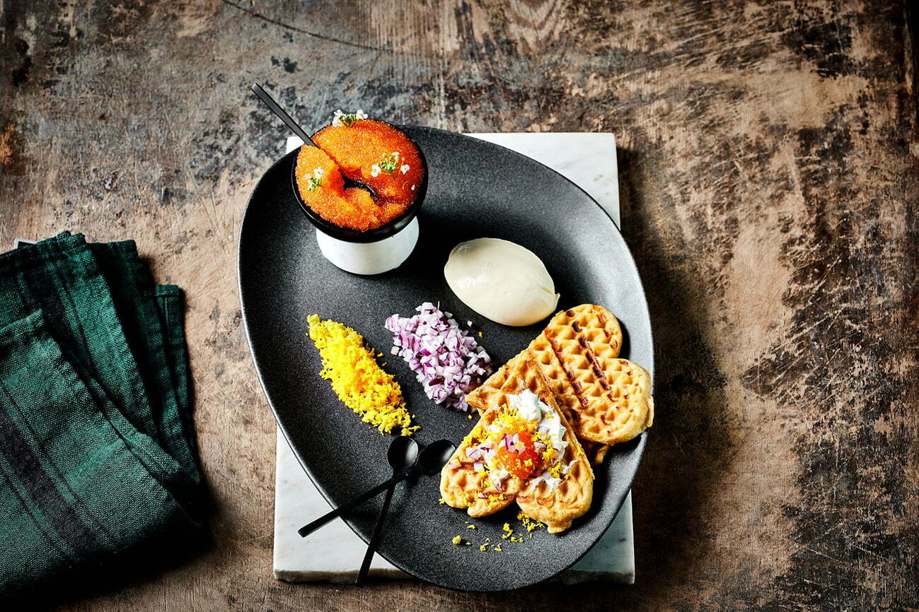 Potato waffle with löyrom and traditional garnish.