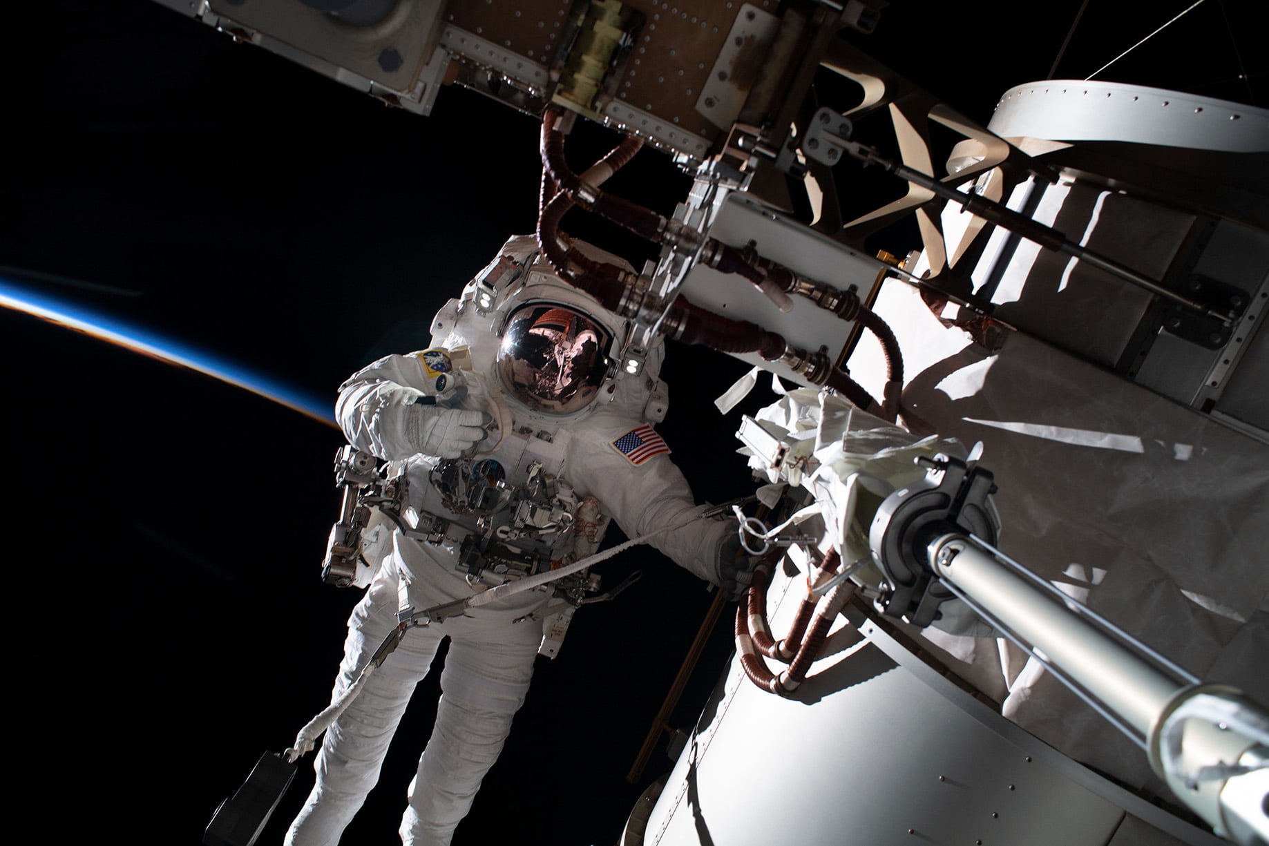 NASA spacewalker Frank Rubio is pictured during a spacewalk tethered to the International Space Station during an orbital sunset.