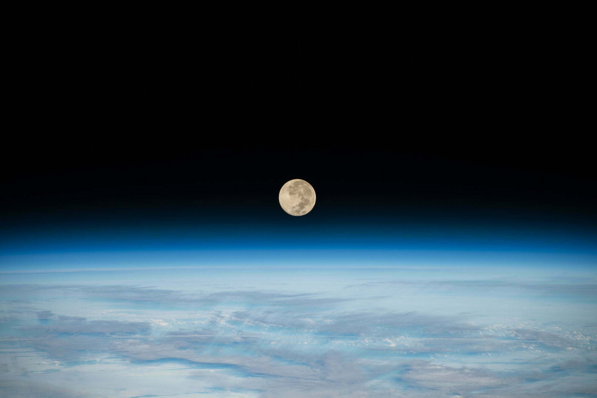 The Full Moon is pictured setting below Earth's horizon from the International Space Station as it orbited 269 miles above the southern Indian Ocean. At the time of this photograph the Orion vehicle on the Artemis I mission was about  207,200 miles from Earth and 180,400 miles from the Moon, cruising at 1,415 mph.