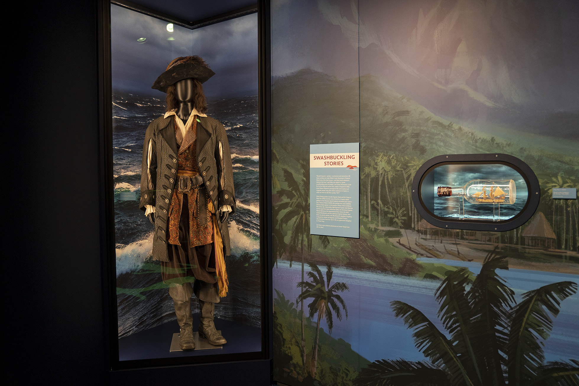 Captain Barbossa costume worn by Geoffrey Rush in Pirates of the Caribbean: The Curse of the Black Pearl (2003) and prop ship in a bottle from Pirates of the Caribbean: On Stranger Tides (2011) on display at Disney100: The Exhibition, now open at The Franklin Institute in Philadelphia. 