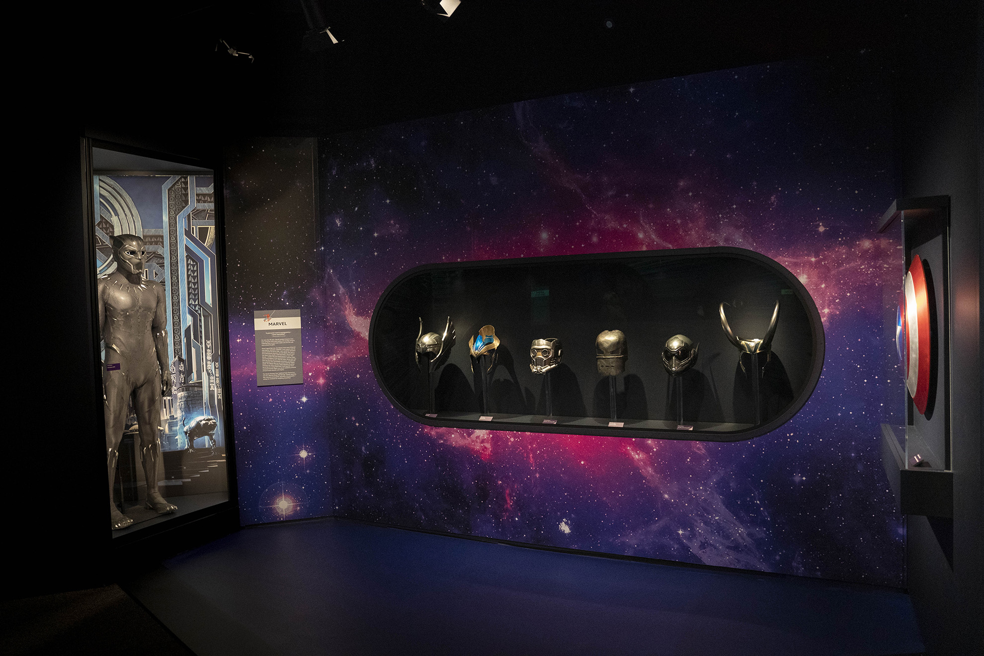 Black Panther costume (Black Panther, 2018), Marvel Studios character helmets and masks, and Captain America shield (Captain America: Civil War, 2016) featured inside The Spirit of Adventure and Discovery gallery at Disney100: The Exhibition, now open at The Franklin Institute in Philadelphia.
