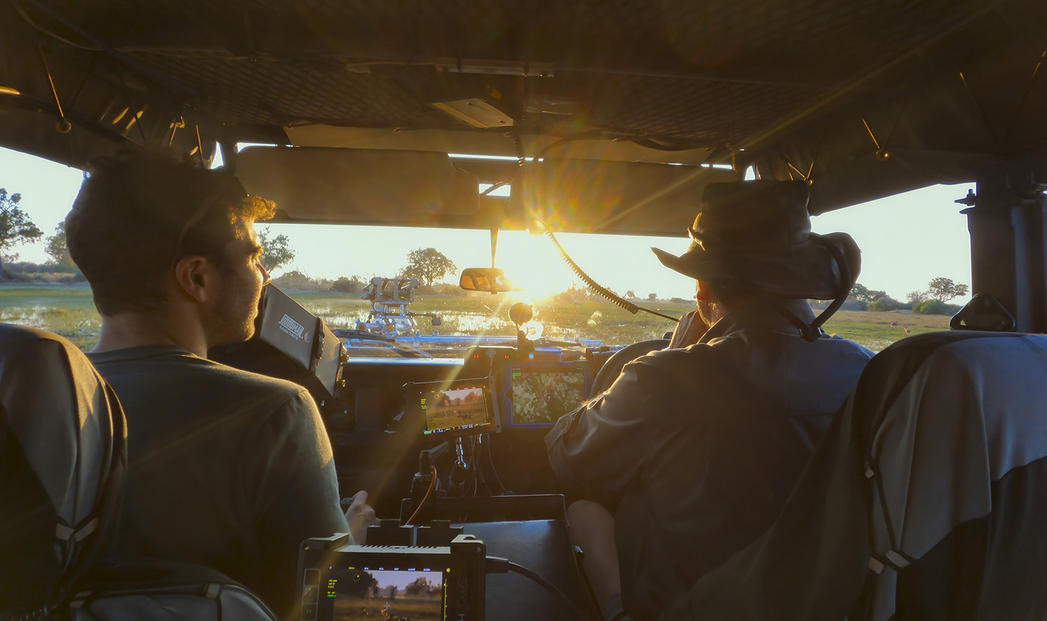 Bertie Gregory and Mike Holding sitting in the front of the 4x4 vehicle.