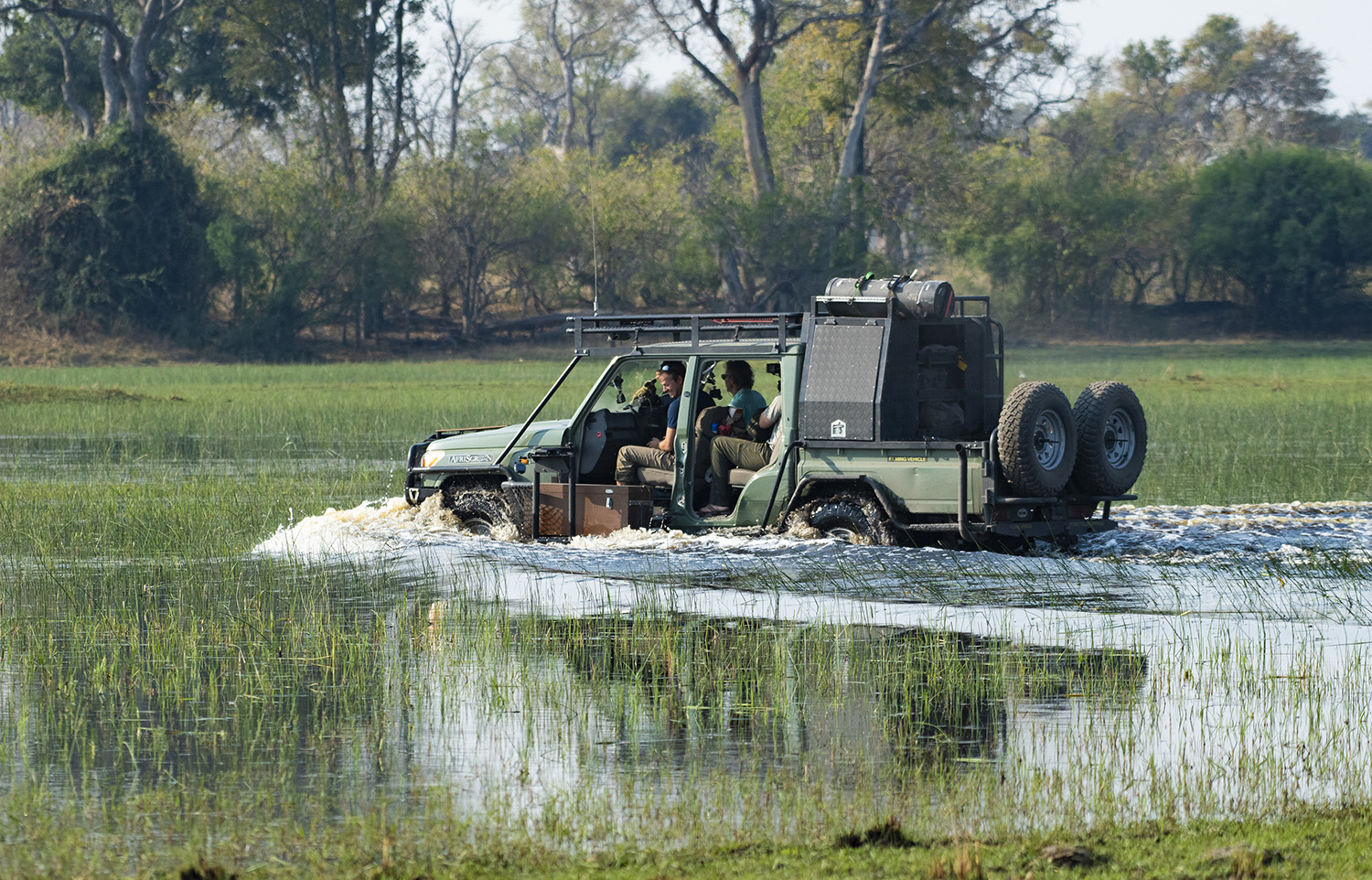 4-wheel drive carrying Bertie Gregory and crew driving through the water.