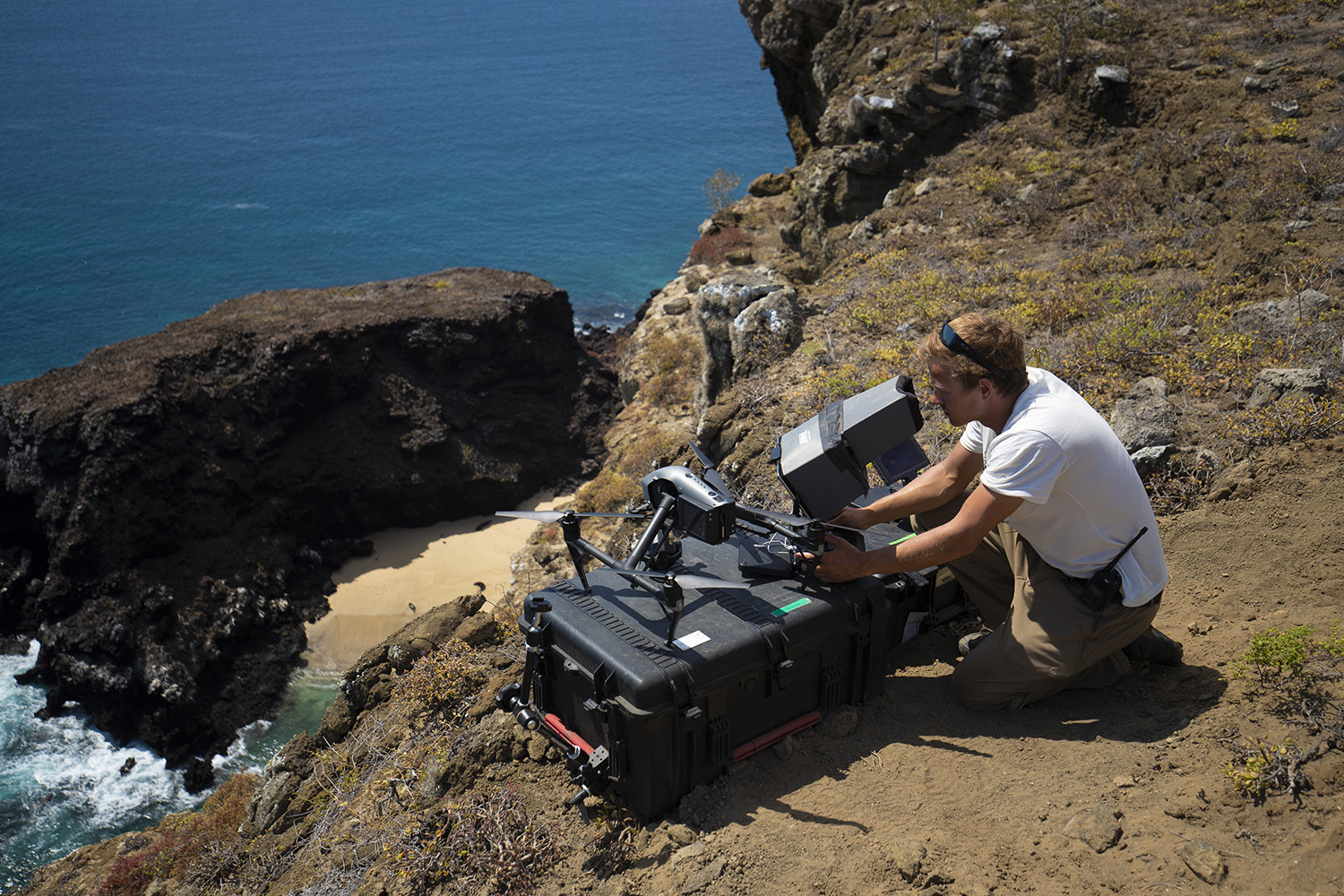 Bertie Gregory views drone footage on a monitor.