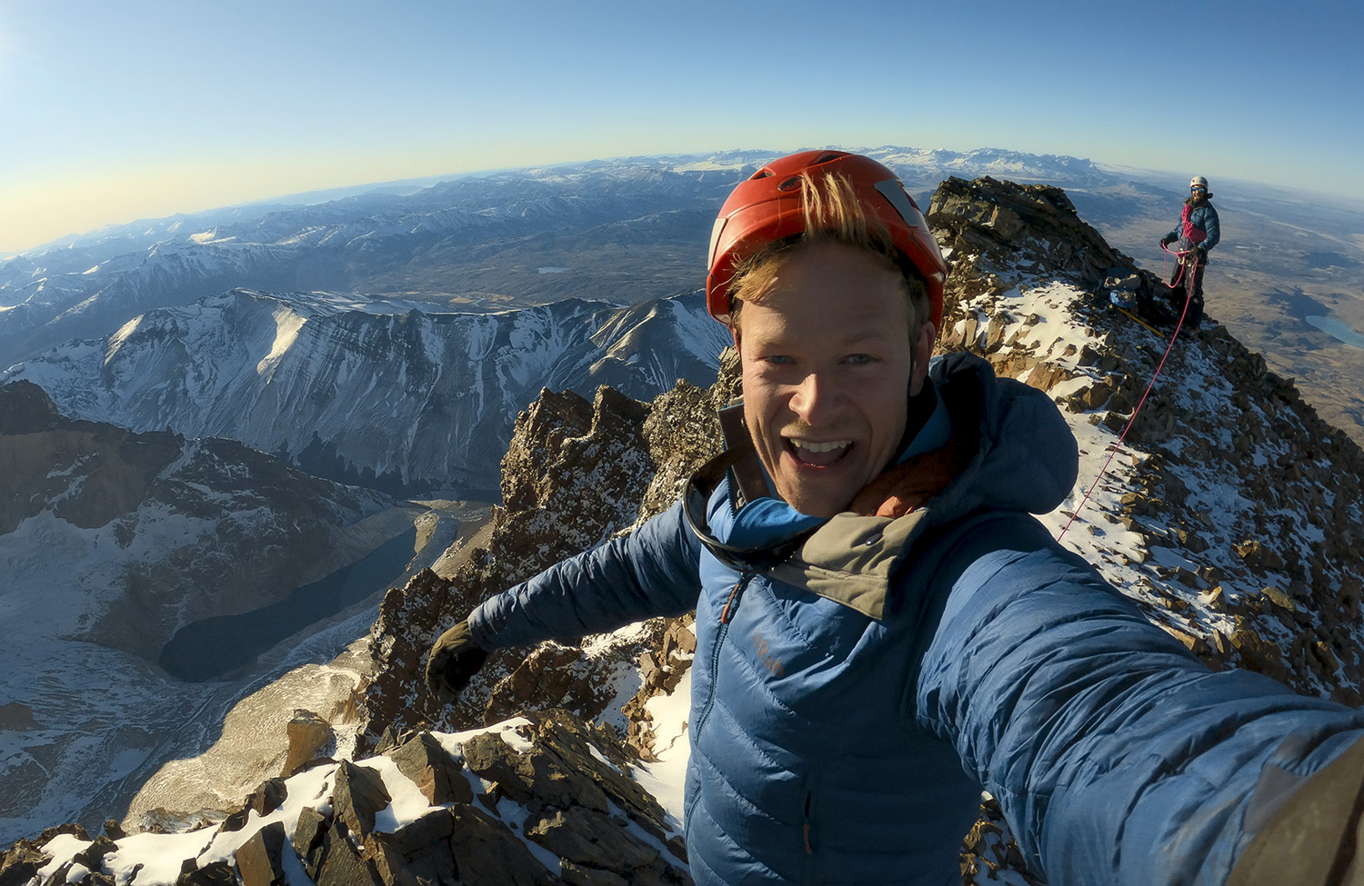 Bertie Gregory taking selfie of himself having reached the peak of the mountain.