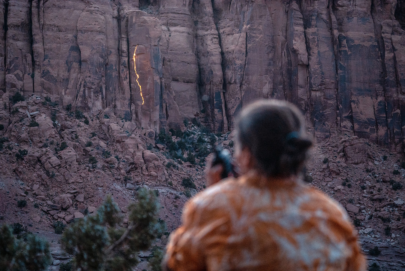 Photographer Krystle Wright takes stationary images of her lighting design on a Long Canyon cliff face. 