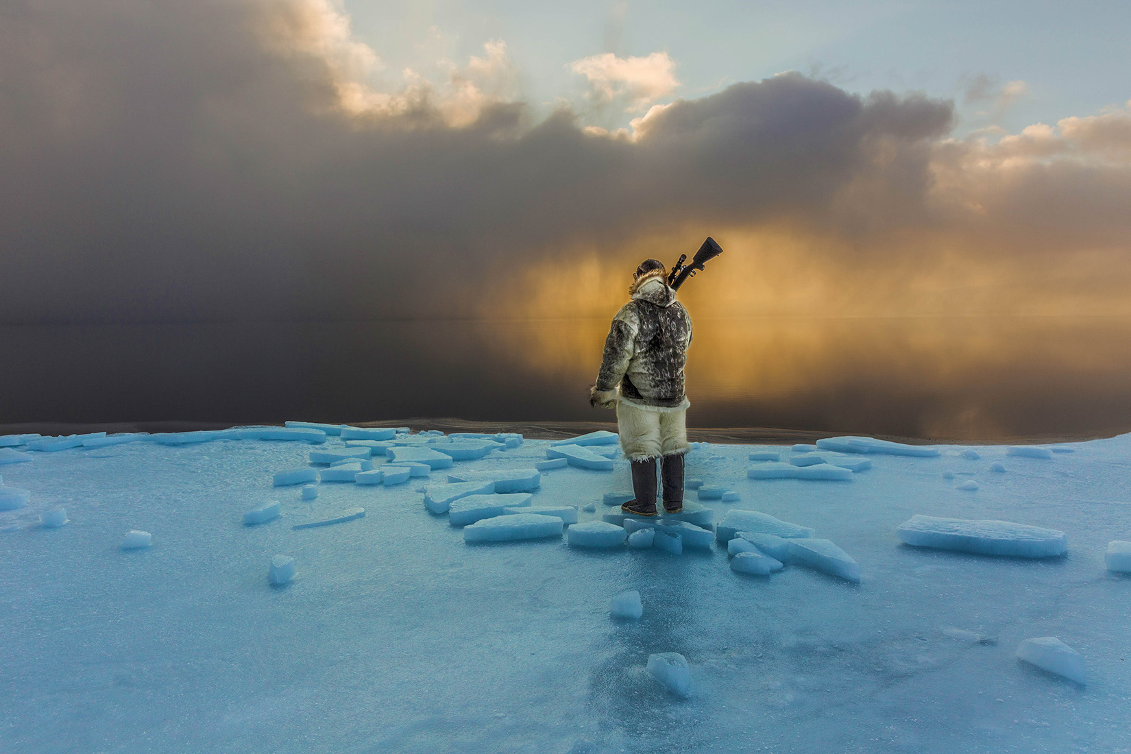 An Inuit hunter of Qaanaaq, Greenland traverses a treacherous course to the ocean's edge in Spring to hunt.