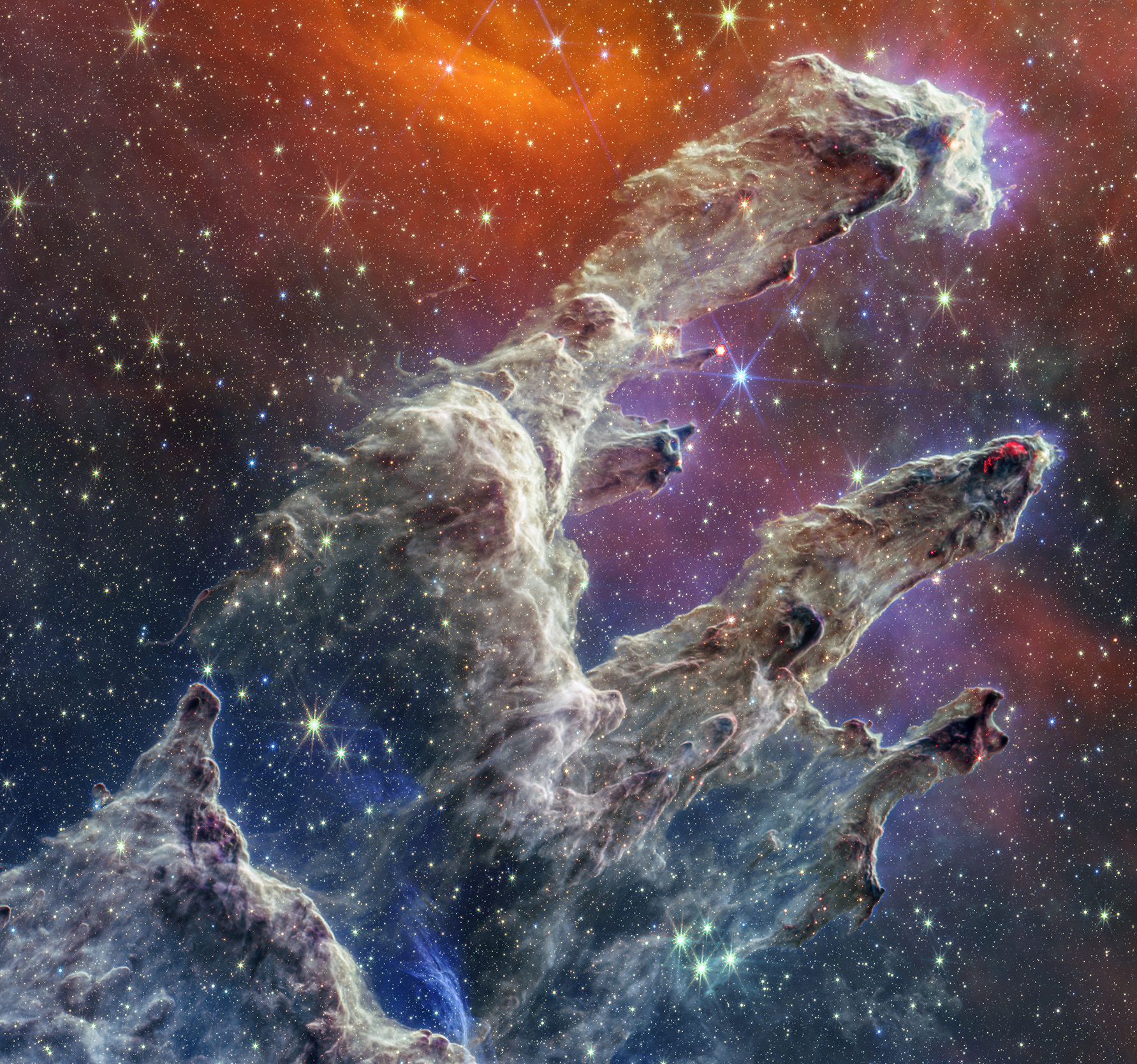 By combining images of the iconic Pillars of Creation from two cameras aboard JWST, the universe has been framed in its infrared glory. Webb’s near-infrared image was fused with its mid-infrared image, setting this star-forming region ablaze with new details.