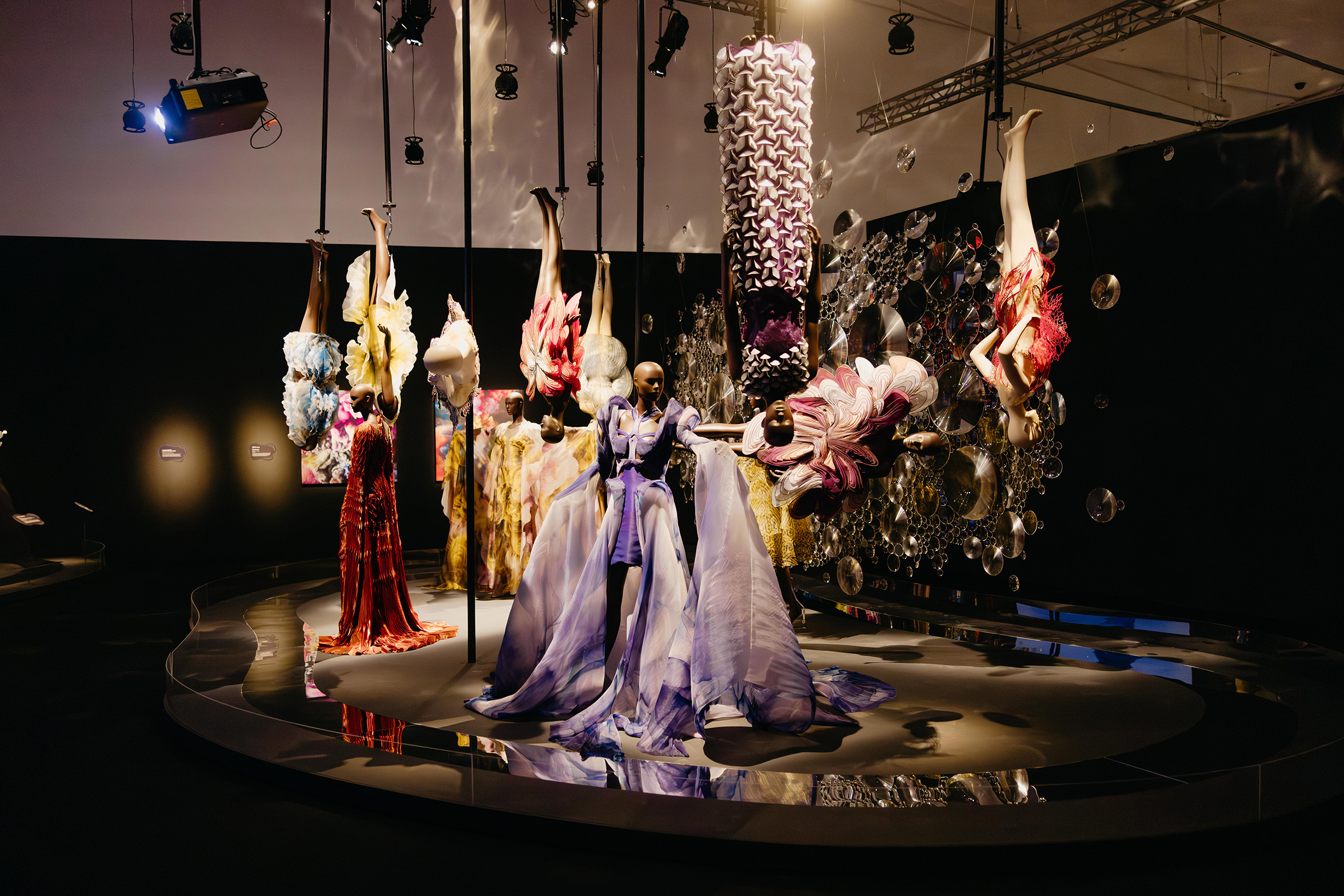The exhibition ends in the Cosmic Bloom zone, where dresses defy the laws of gravity