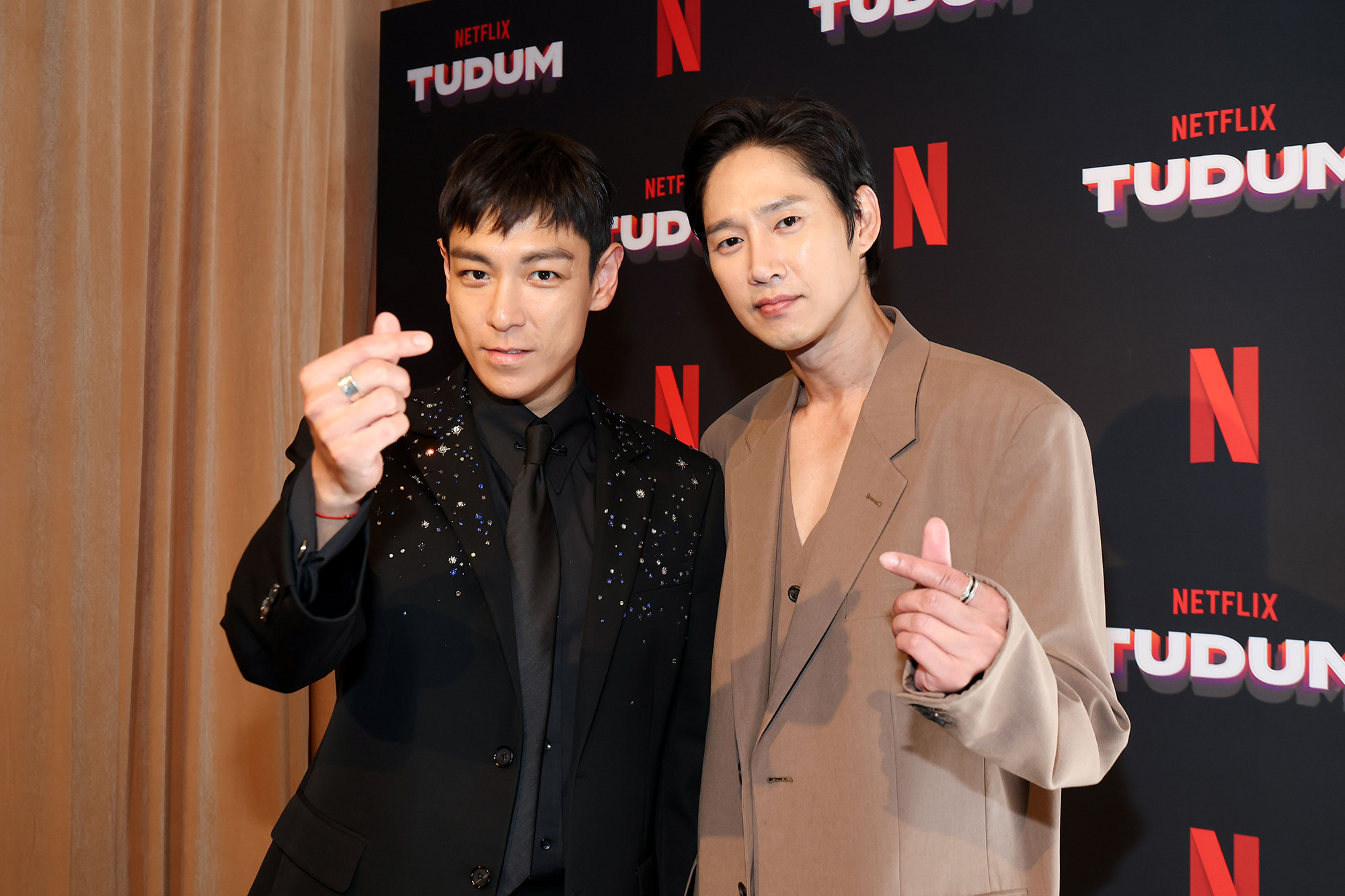 (L-R) Choi Seung-hyun aka T.O.P and Park Sung-hoon attend NETFLIX TUDUM 2025: THE LIVE EVENT at The Kia Forum on May 31, 2025 in Inglewood, California.