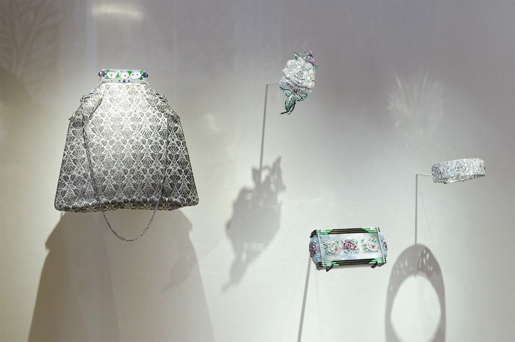 Left: “Evening Bag,” 1927 Center, top: “Rose Brooch,” 1925 Center, bottom: “Rose Vanity Case,” 1926 Right: “Bracelet,” 1925 (All from the Van Cleef & Arpels Collection)