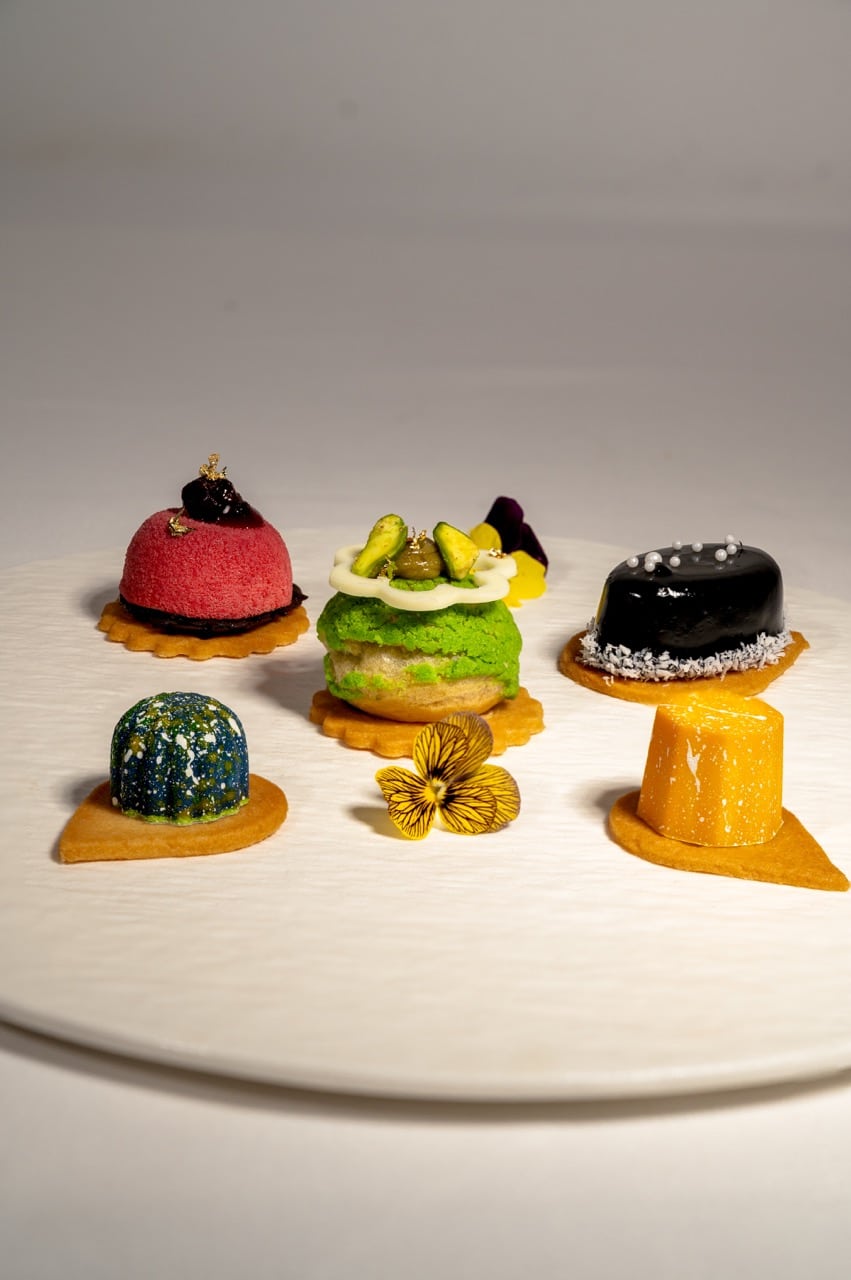 SWEET DELIGHT-Petit Fours with chocolate bonbon, choux pastry, sesame cheesecake, and raspberry chocolate - The Anam Mui Ne